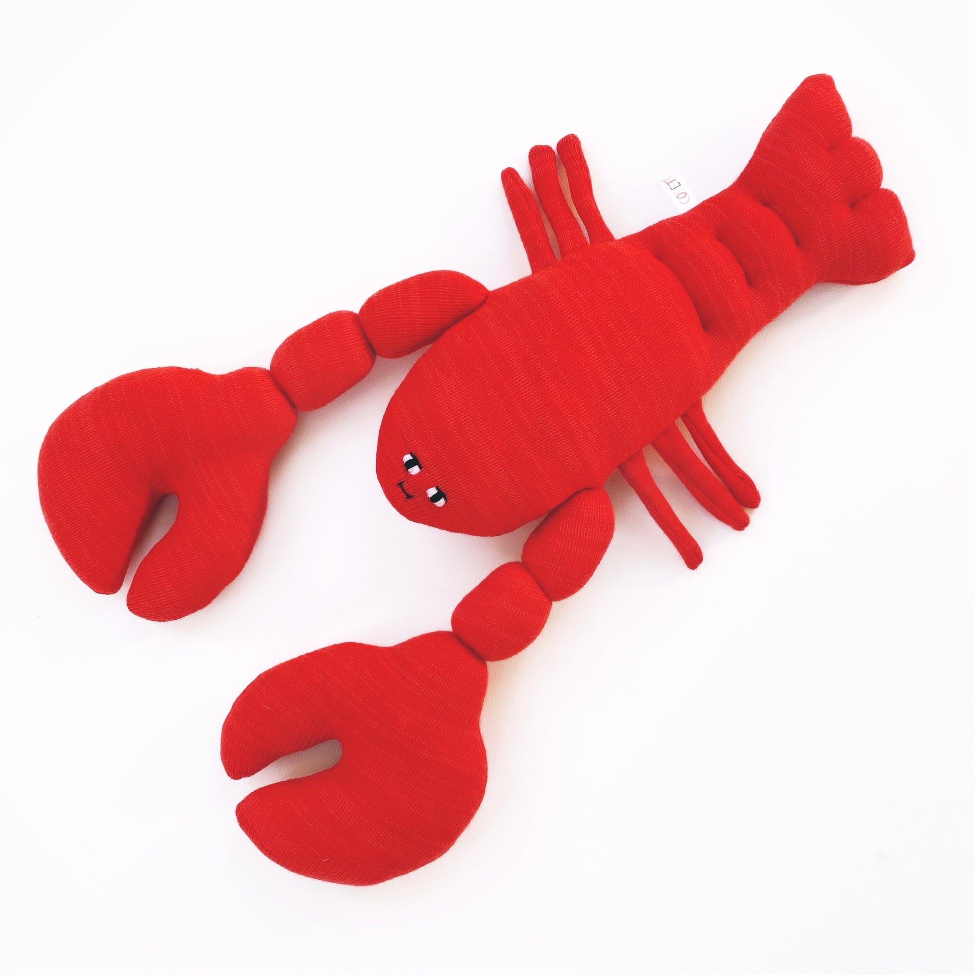 Red lobster-shaped toy on a white background