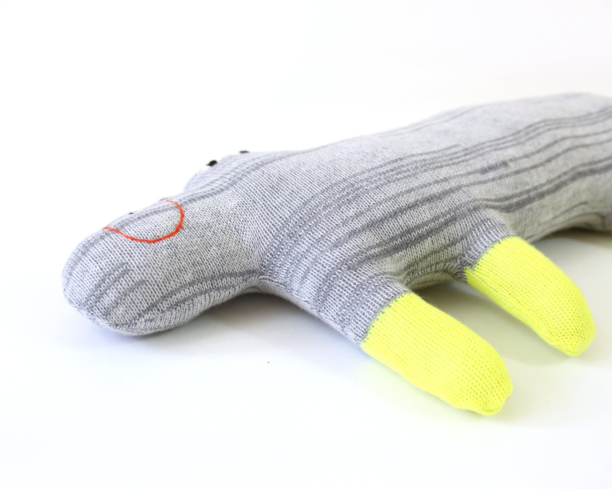 Gray knitted lambswool hippo plush toy with yellow feet on a white background