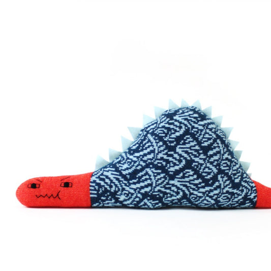 Lambswool toy shaped like a red dinosaur with blue spiky back on a white background