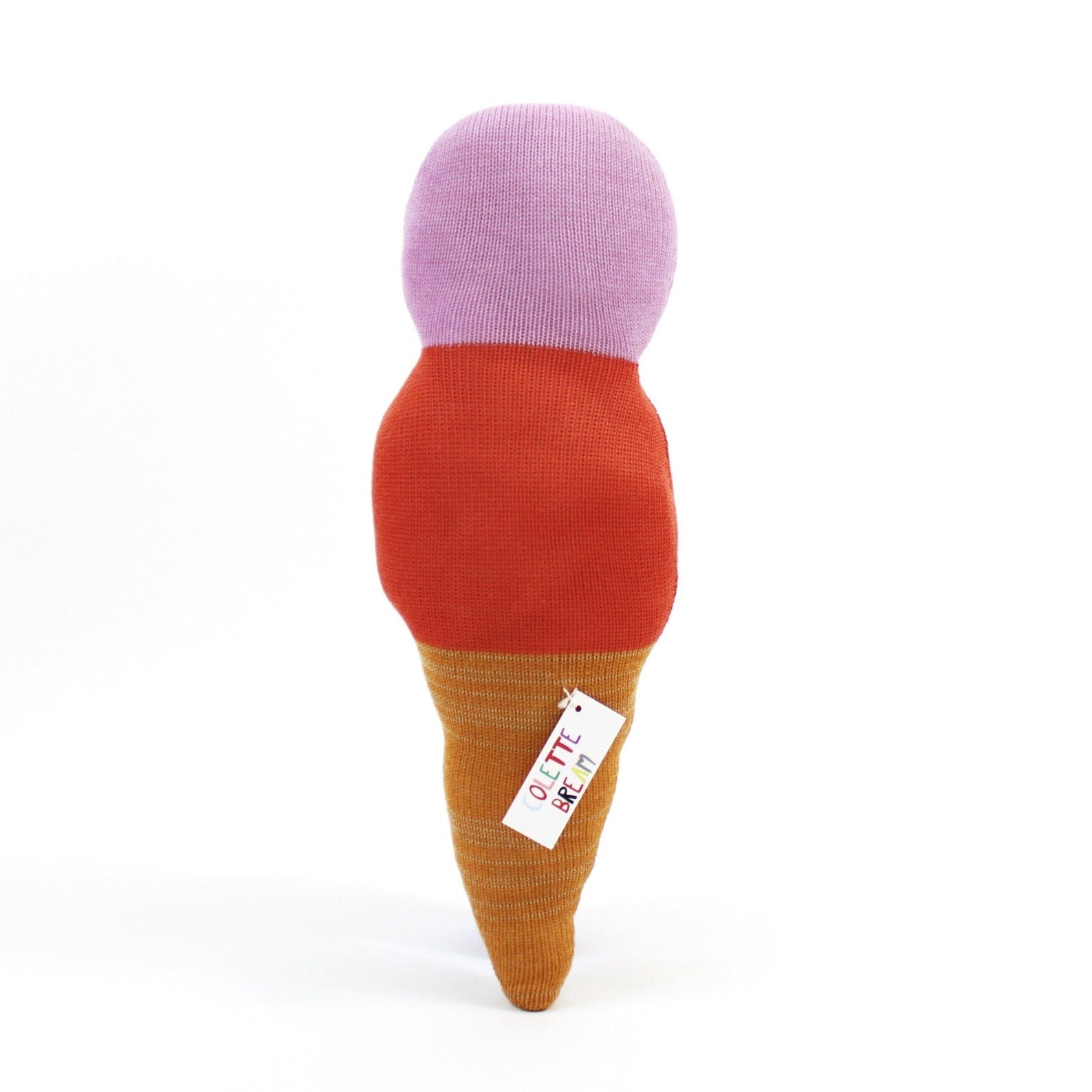 Toy resembling an ice cream cone with a purple top, red middle, and brown base on a white background.