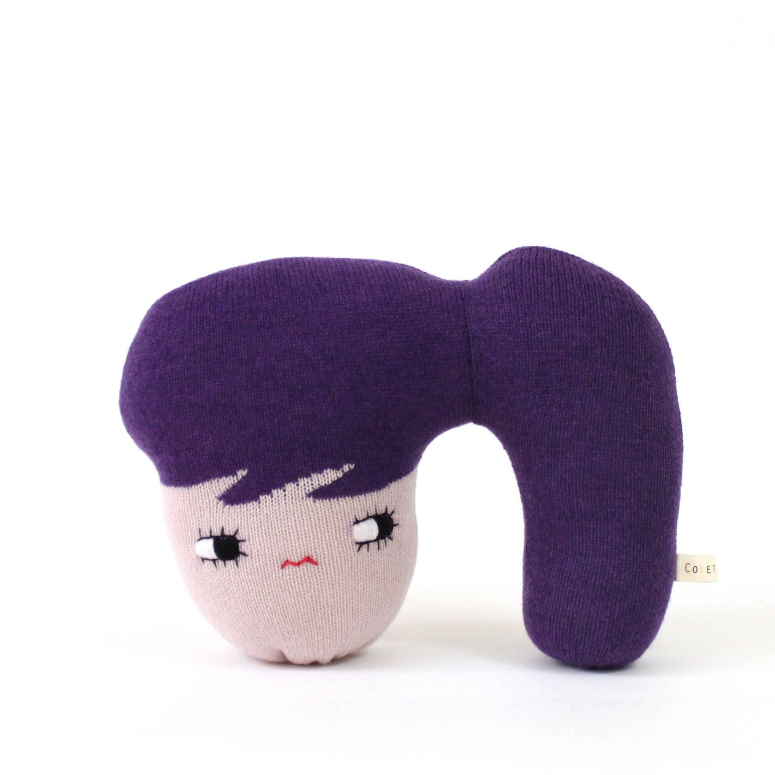 Soft knit doll with a face design and ponytail on a white background