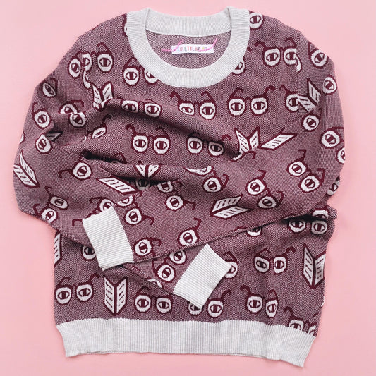 Knit Sweater with a unique pattern of spectacles glasses on a pink background background