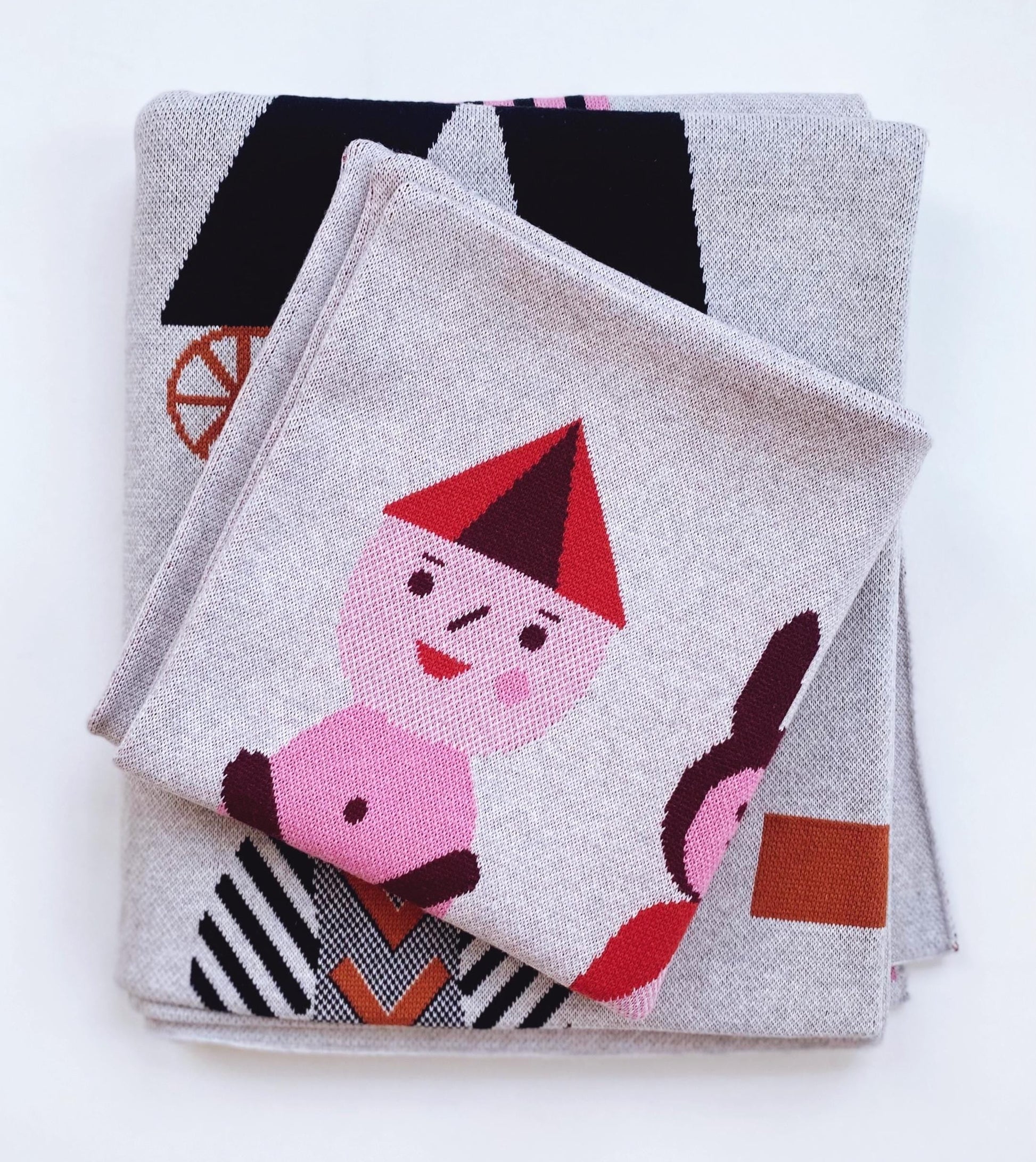 Stack of folded fabric with cartoon character design on a white background