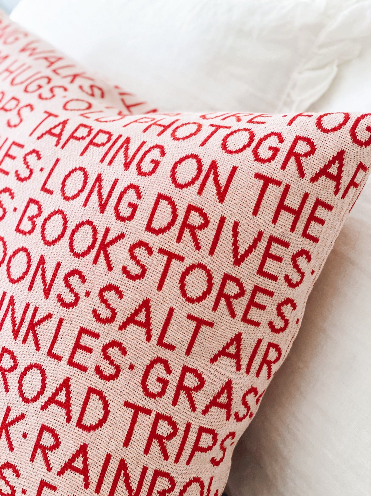 Pillow with red text on a white background