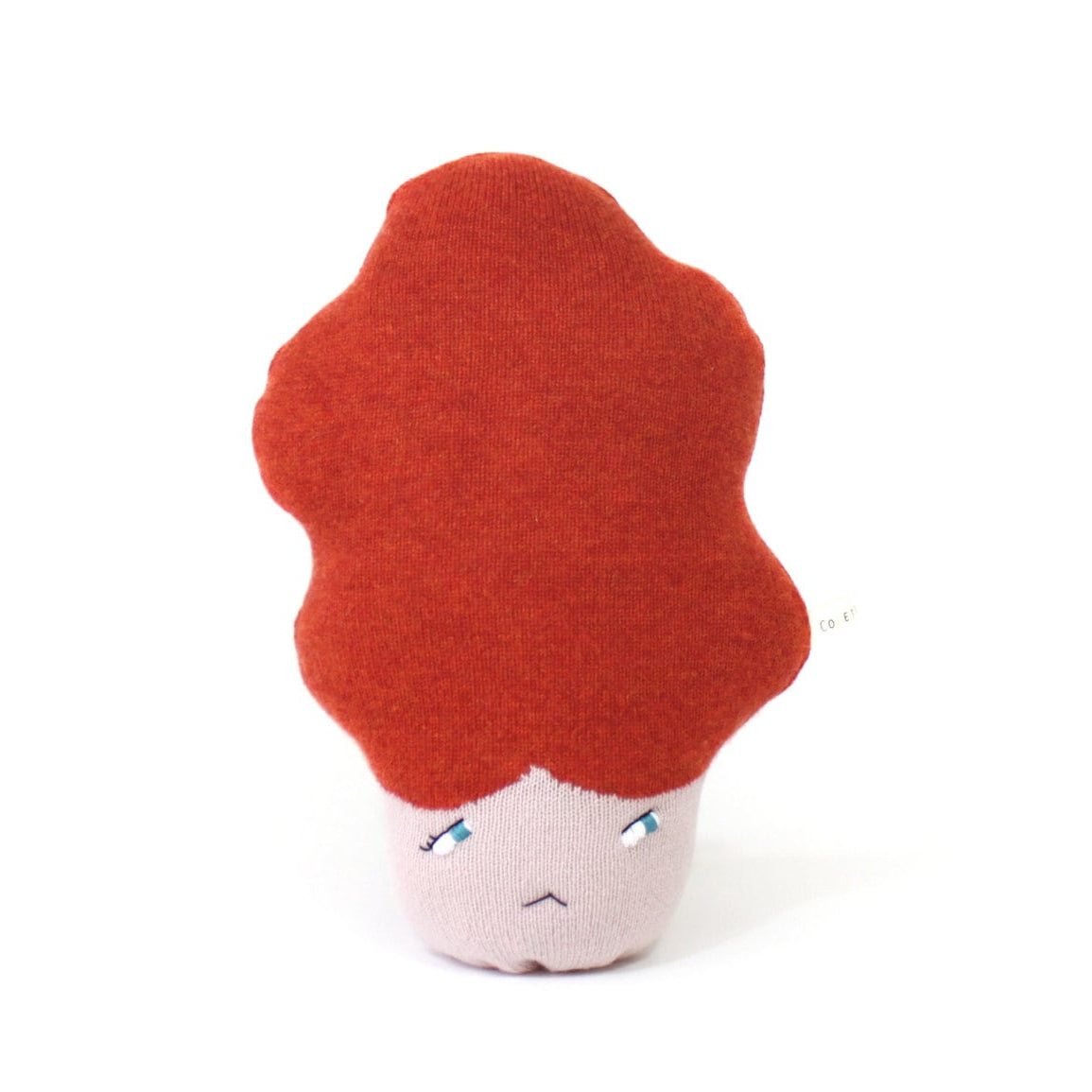 Plush toy with red hair and a sad expression on a white background