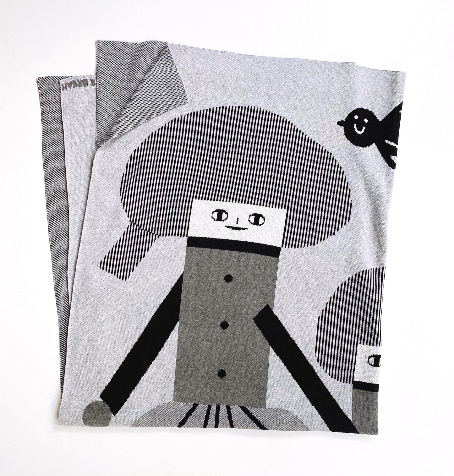 Knitted blanket with a cartoon character design on a white background