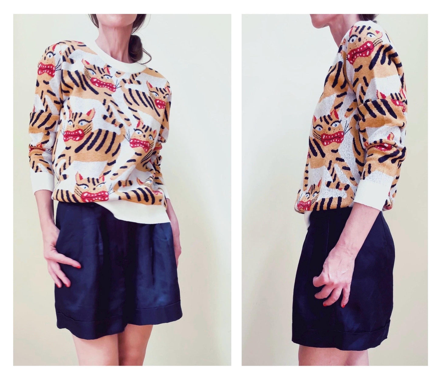 Person wearing a sweater with Hariko Tora tiger print and navy shorts on a plain background