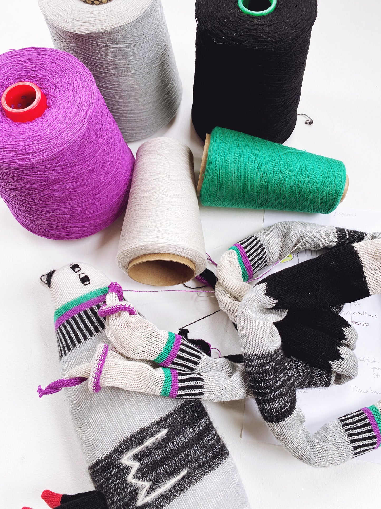 colorfull yarns and knitted fabric on white background
