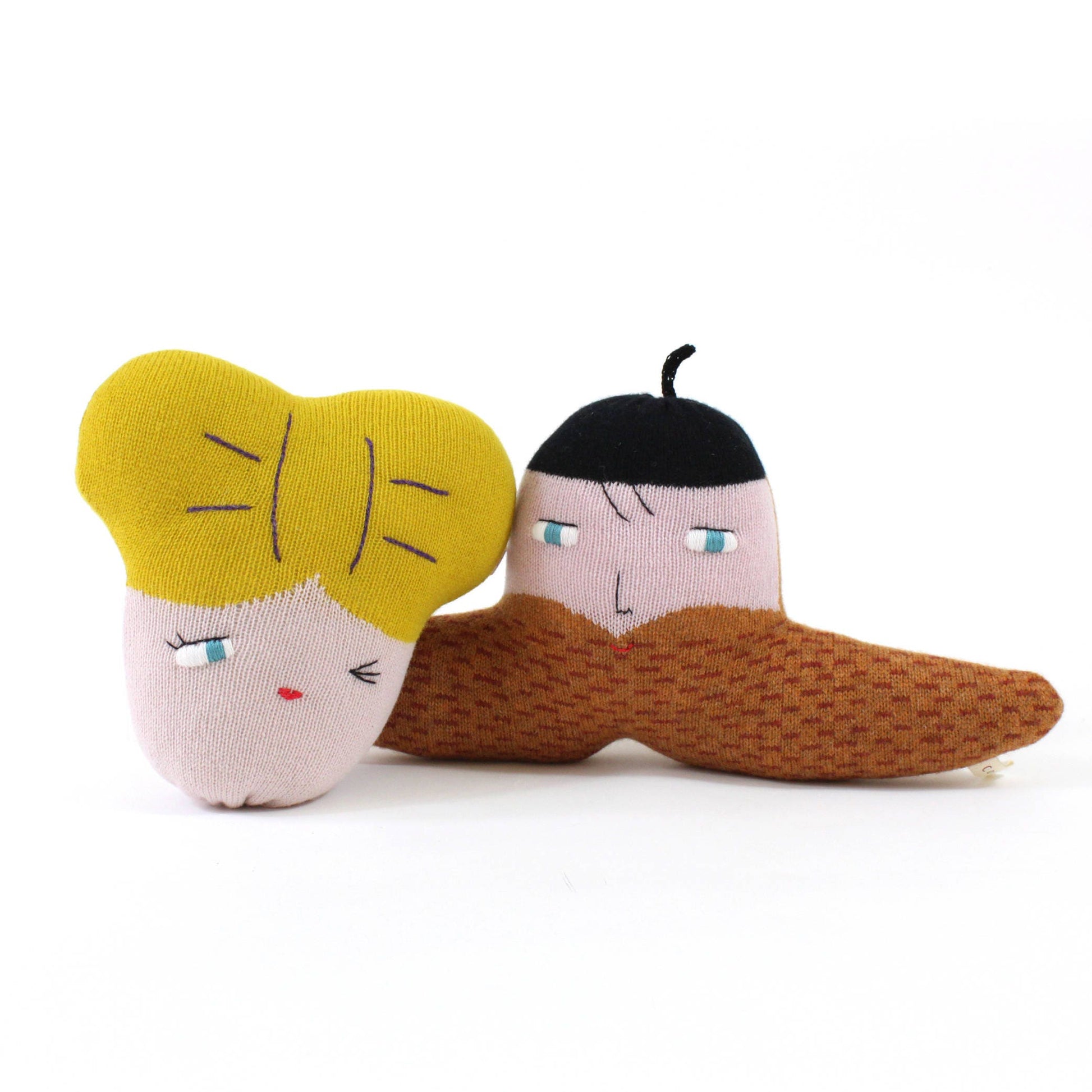 Two knitted characters, one with yellow hair and the other with brown mustache, on a white background.
