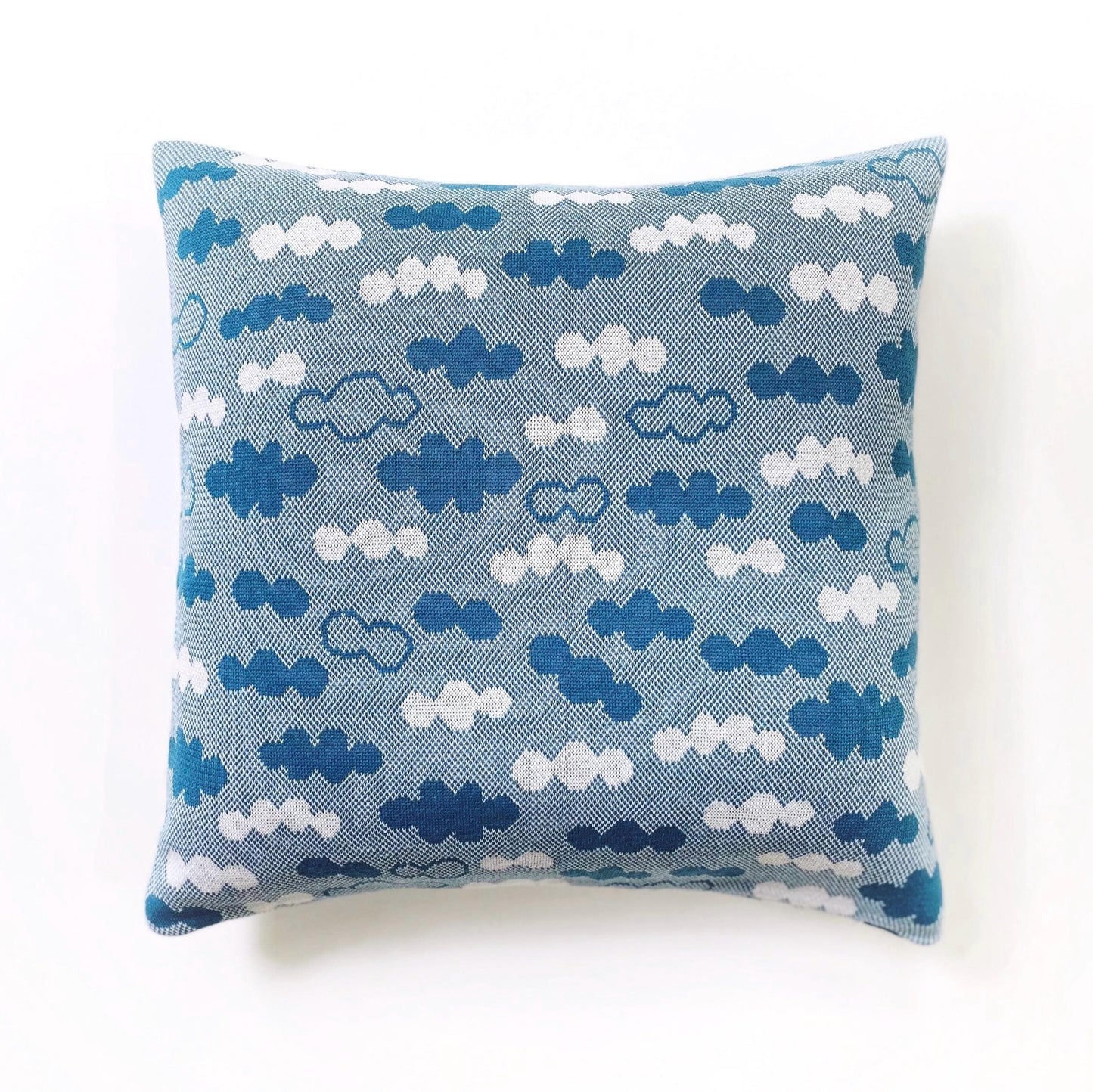 Decorative pillow with blue and white cloud pattern on a white background