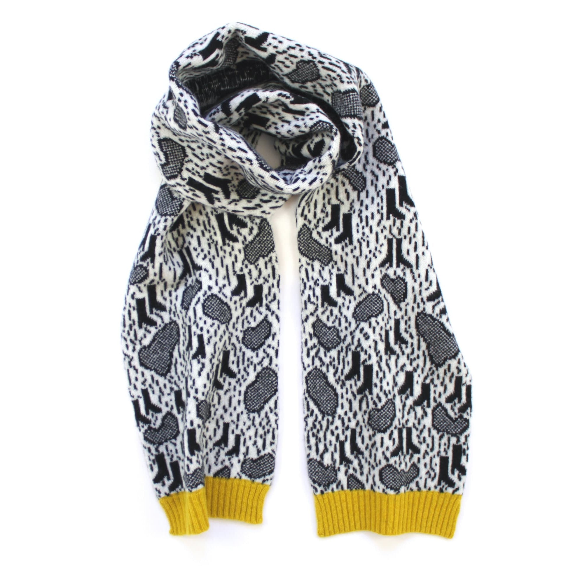 Black and white patterned scarf with yellow trim on a white background