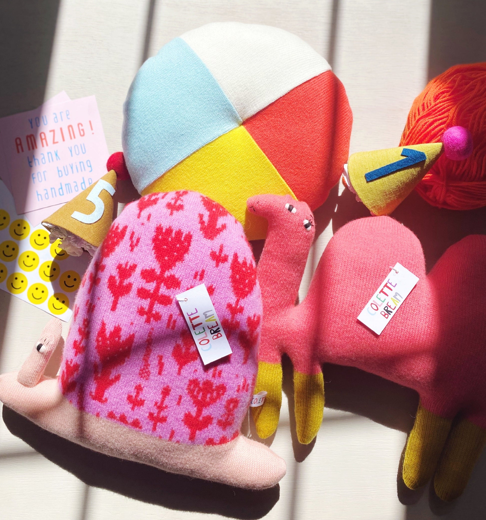 Colorful plush toys with tags on a white background