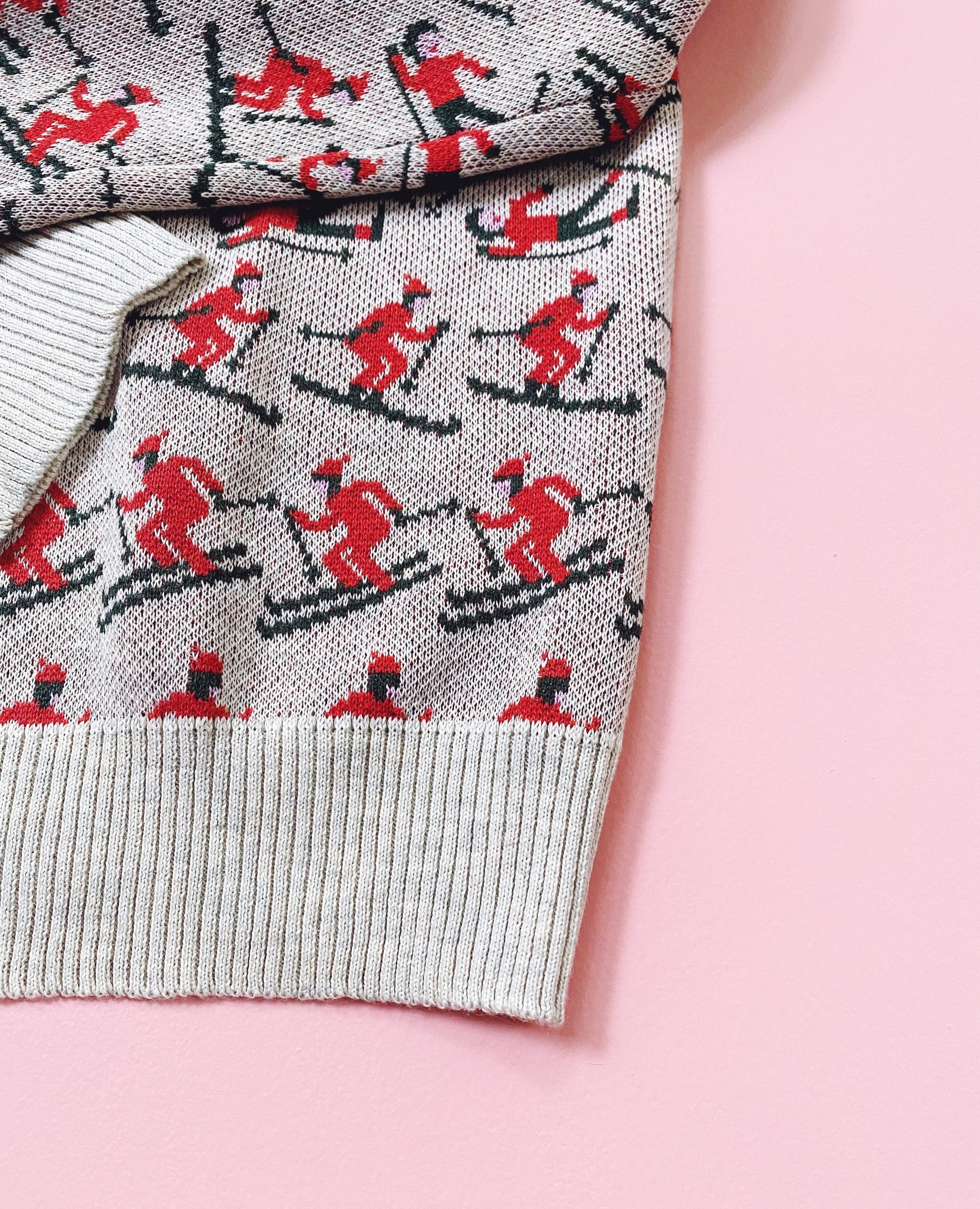 Sweater with skier pattern on a pink background