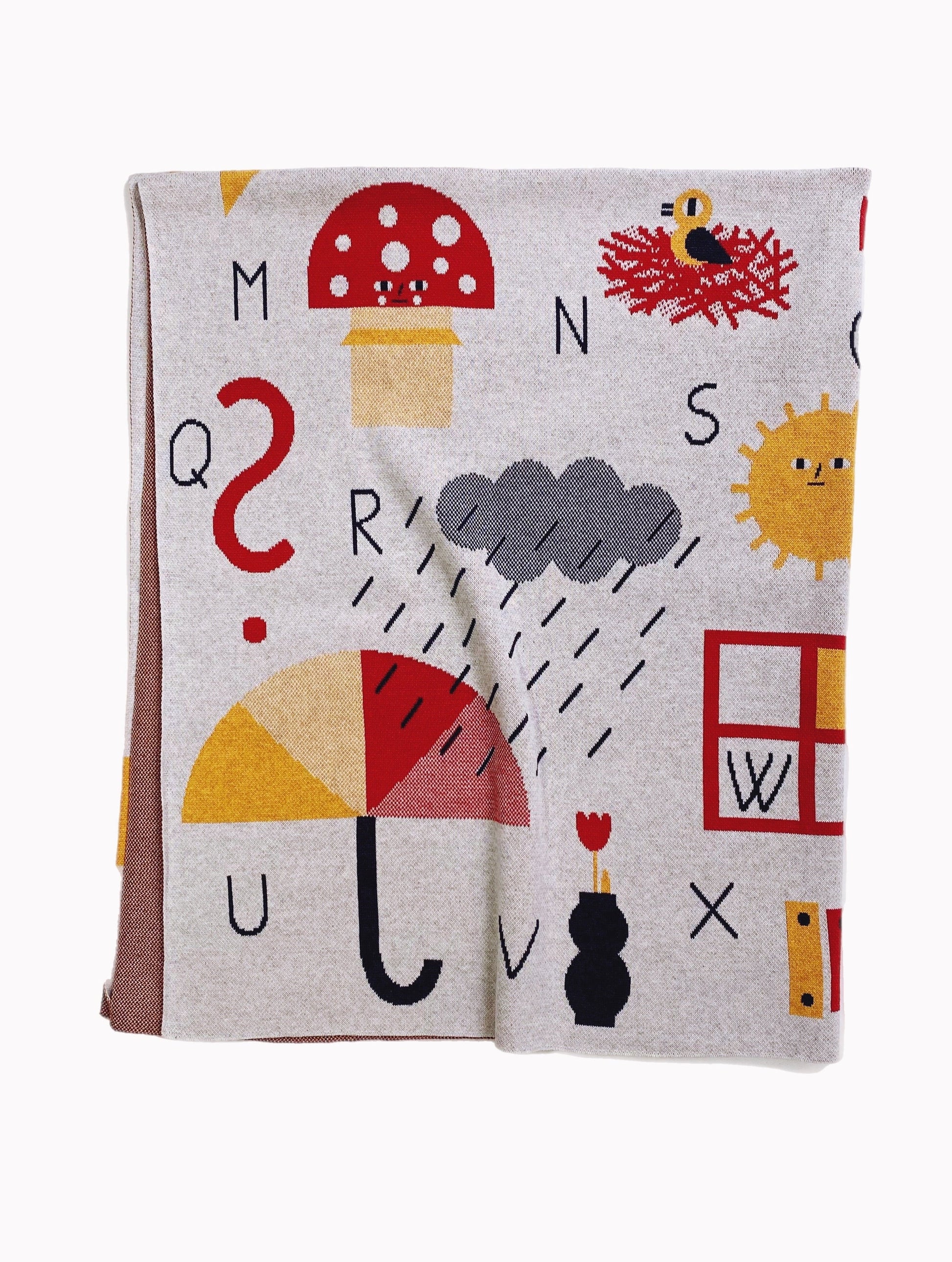 Children's knitted alphabet throw blanket with colorful letters and symbols on a white background