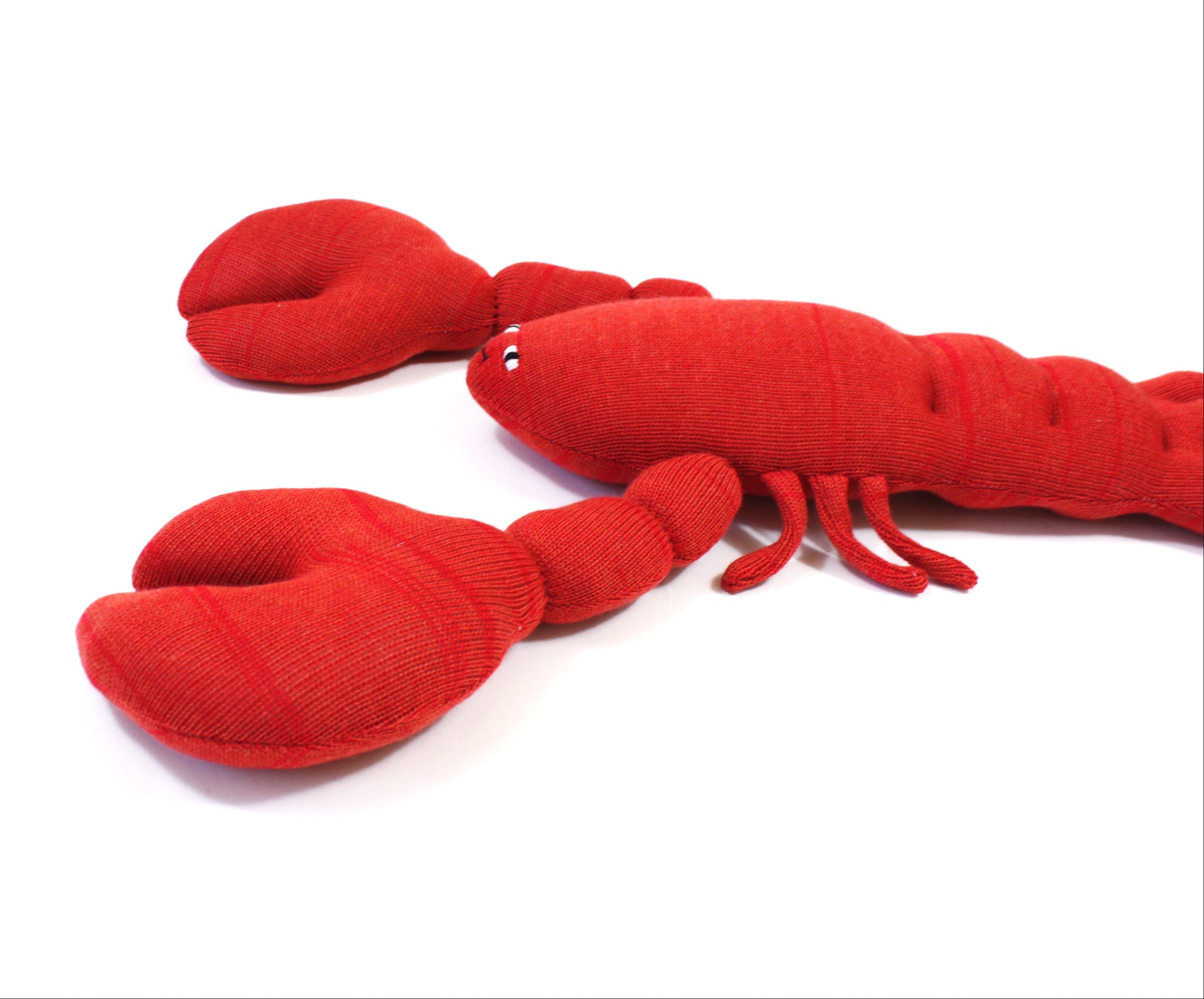 Red plush lobster toy on a white background