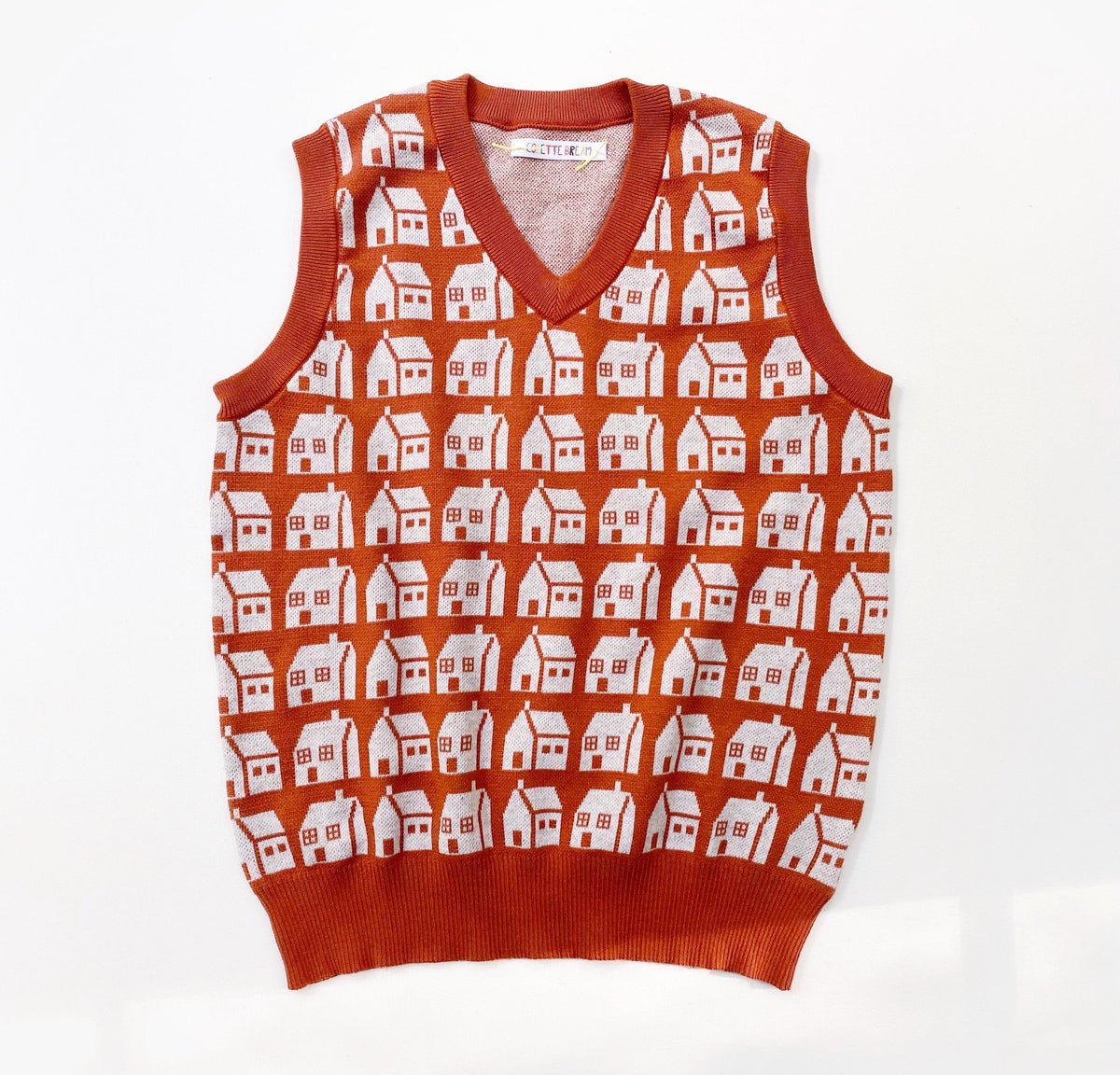 Orange sweater vest with white house pattern on a white background