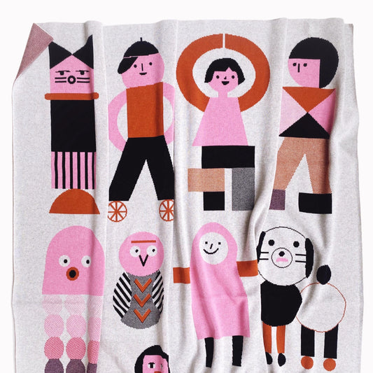 Blanket with colorful abstract character design on a white background