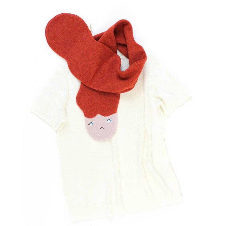 Red scarf with a face design on a white background