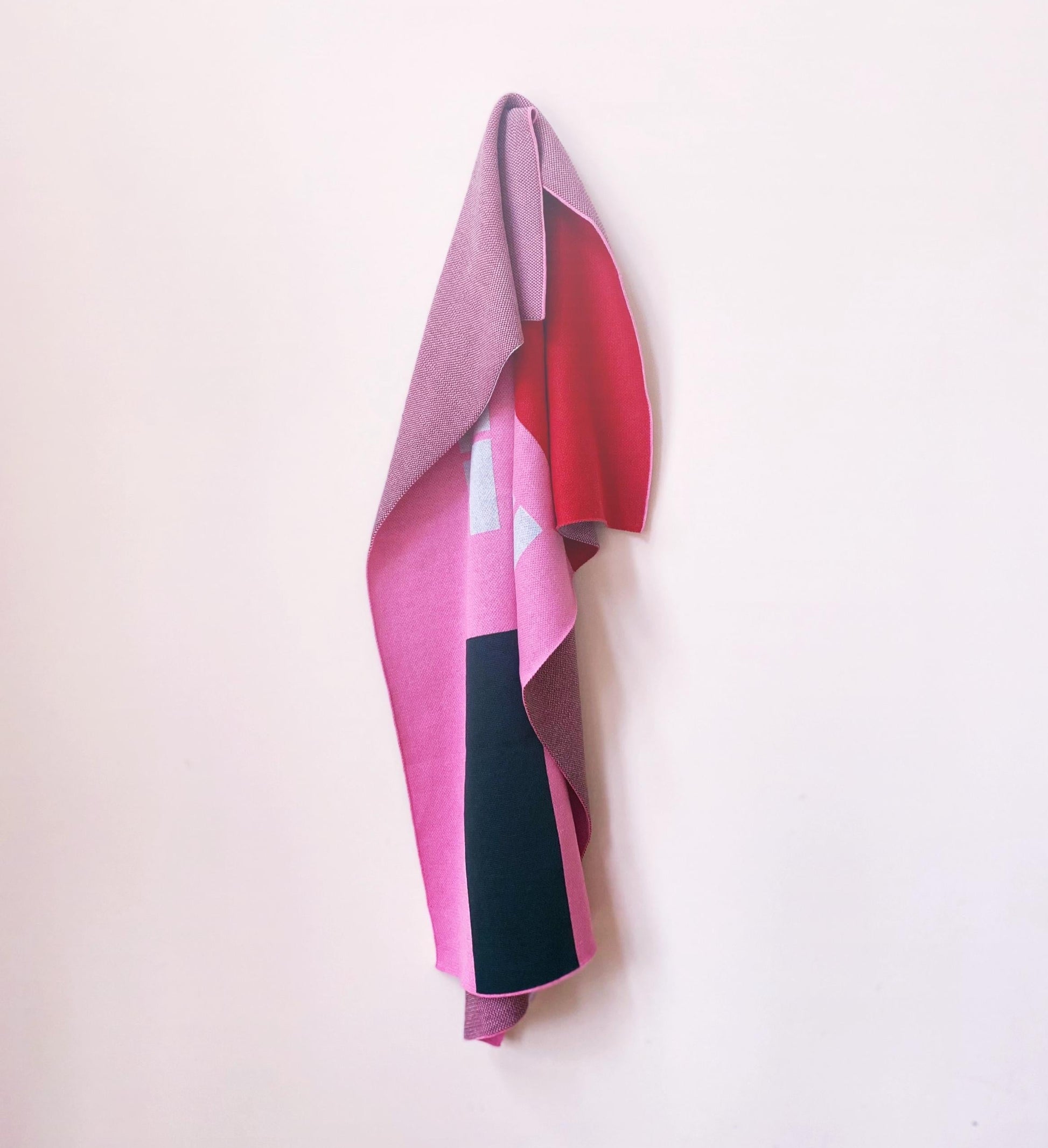 Colorful knitted blanket with house pattern design on white background