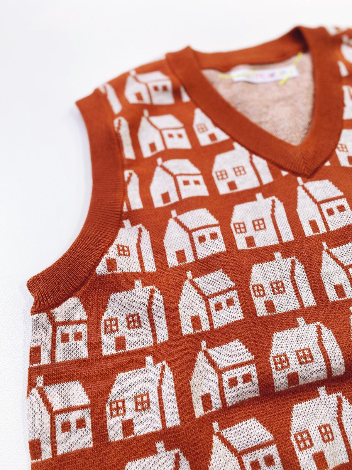 Knitted sleeveless sweater vest with house pattern on a white background