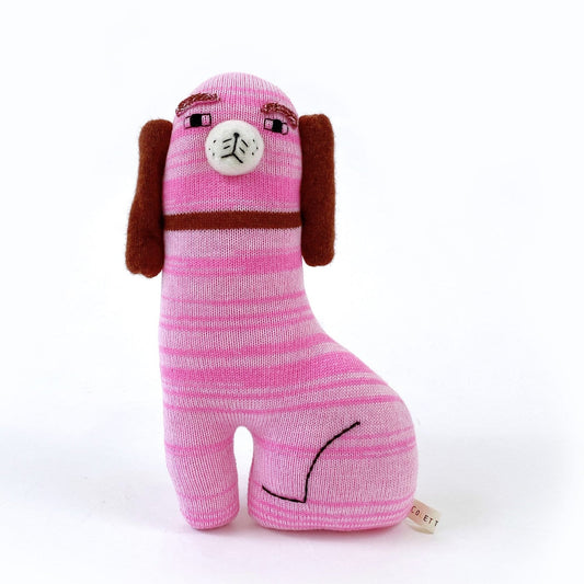 Pink knitted Staffordshire dog-shaped toy with brown ears on a white background