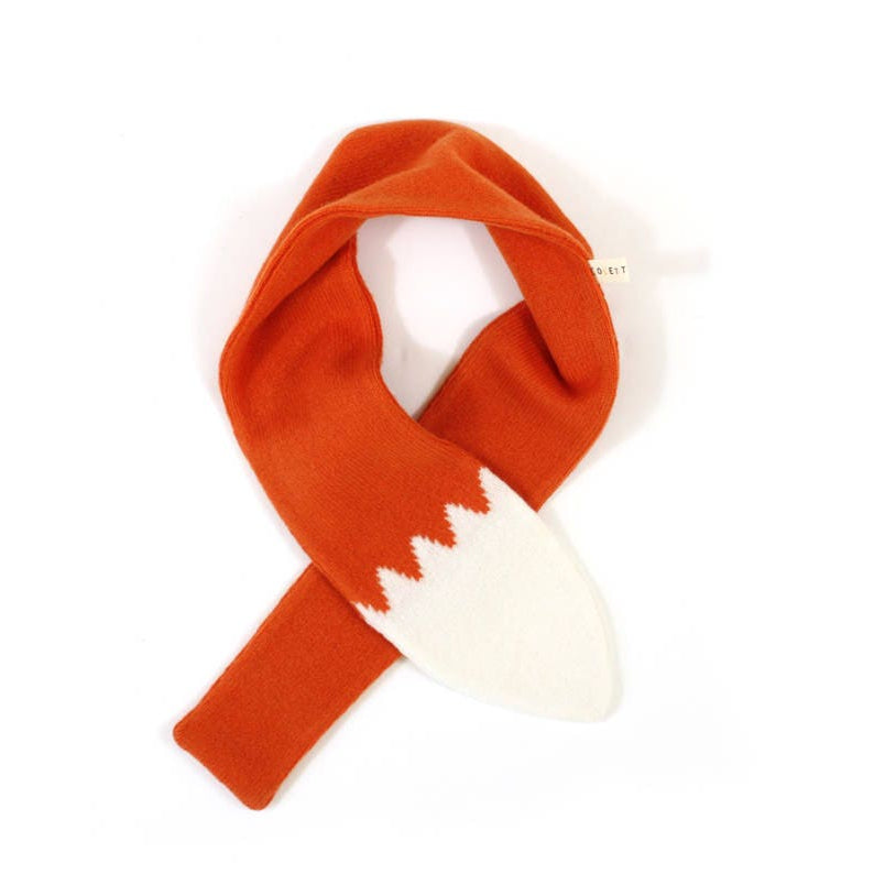 Orange and white knitted lambswool scarf shaped like a fox tail on a white background