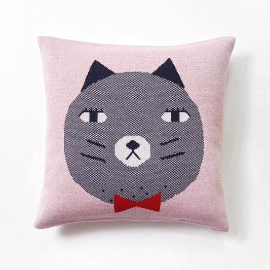 Knitted cushion with a cat face design on a pink background