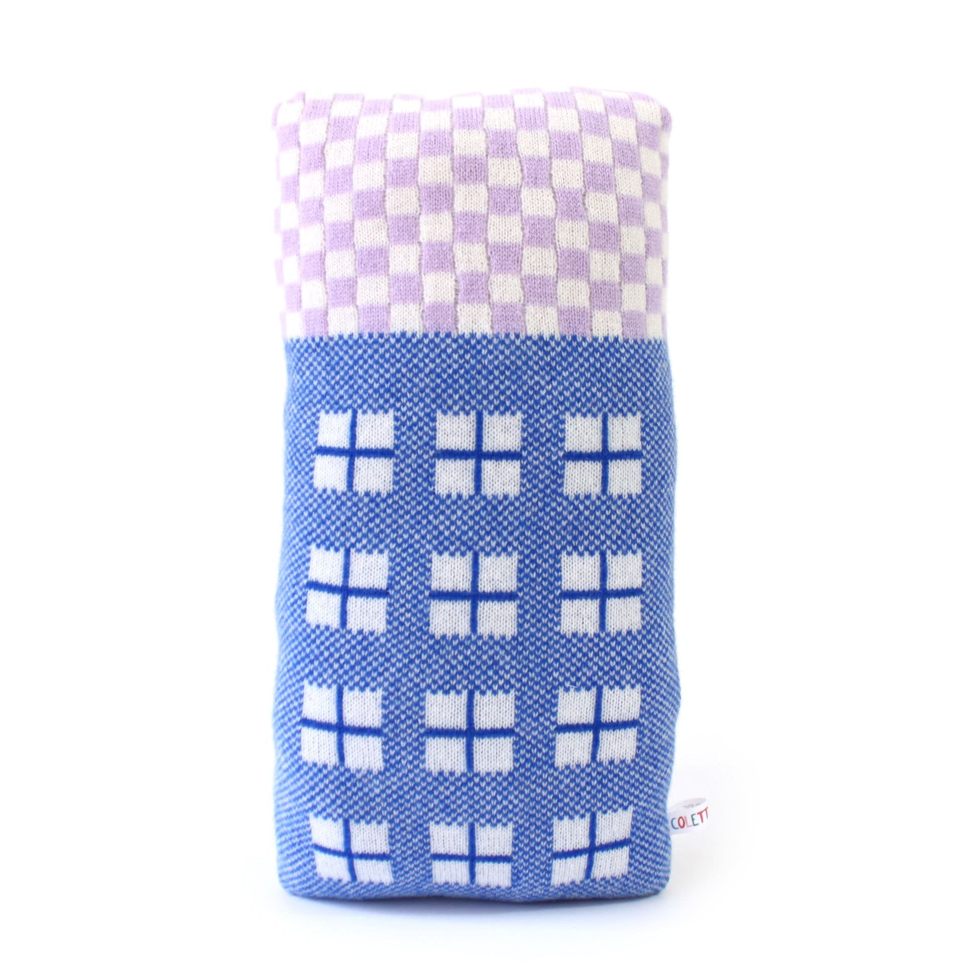 Knitted lambswool house cushion with blue and white pattern on a white background