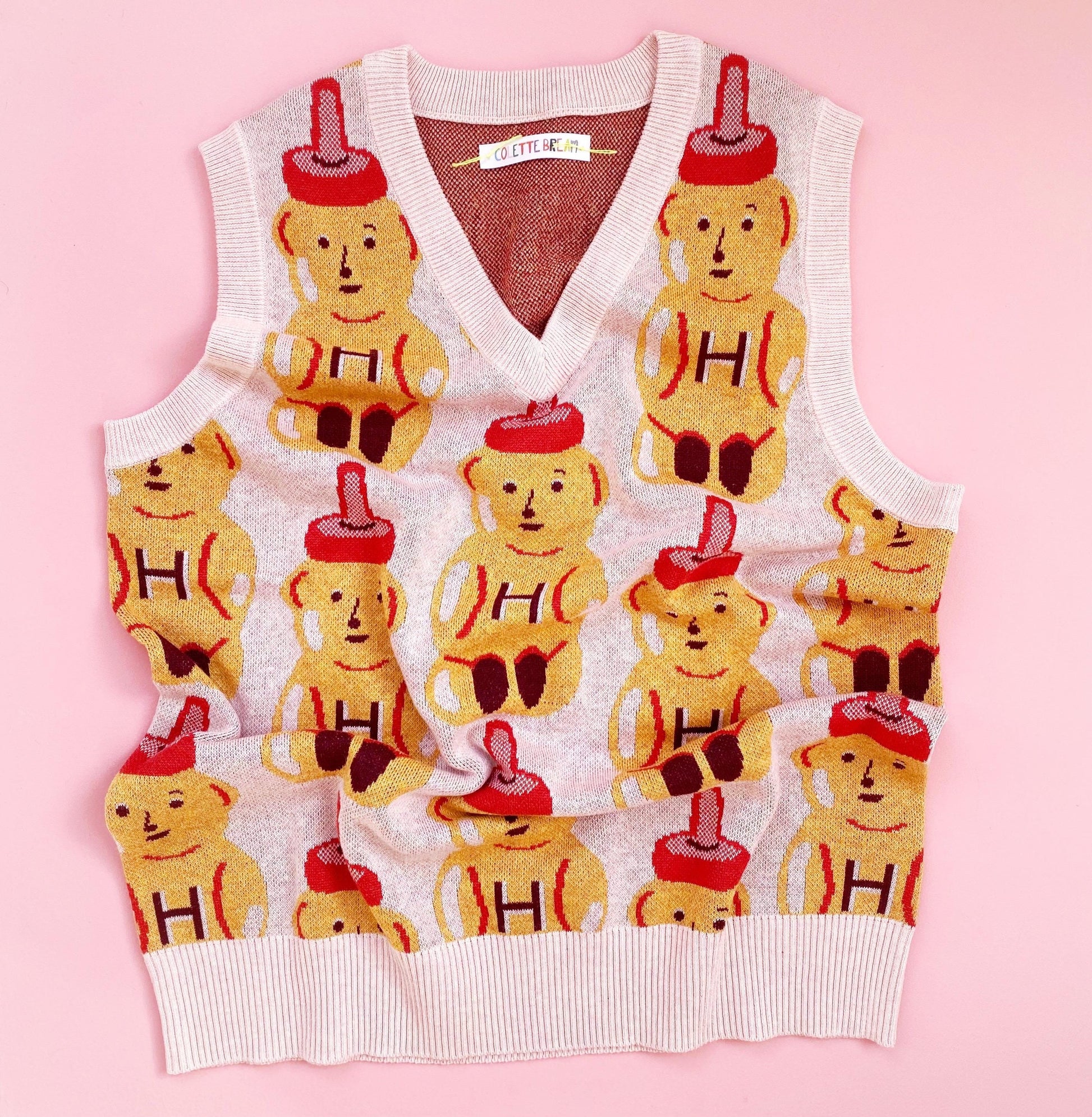 Sweater vest with honey bear pattern on a pink background