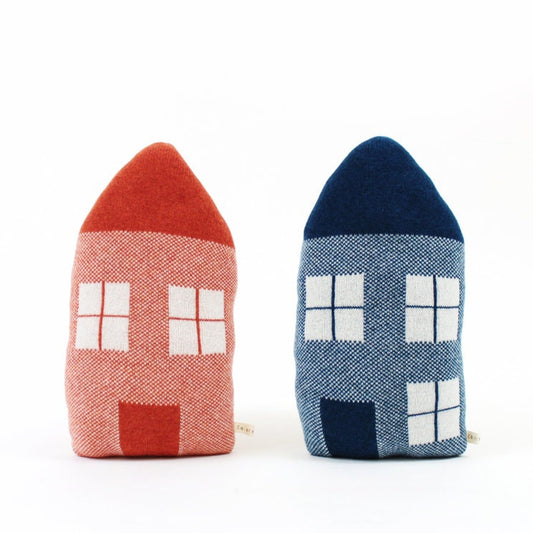 Two knitted house-shaped pillows, one red and one blue, on a white background.