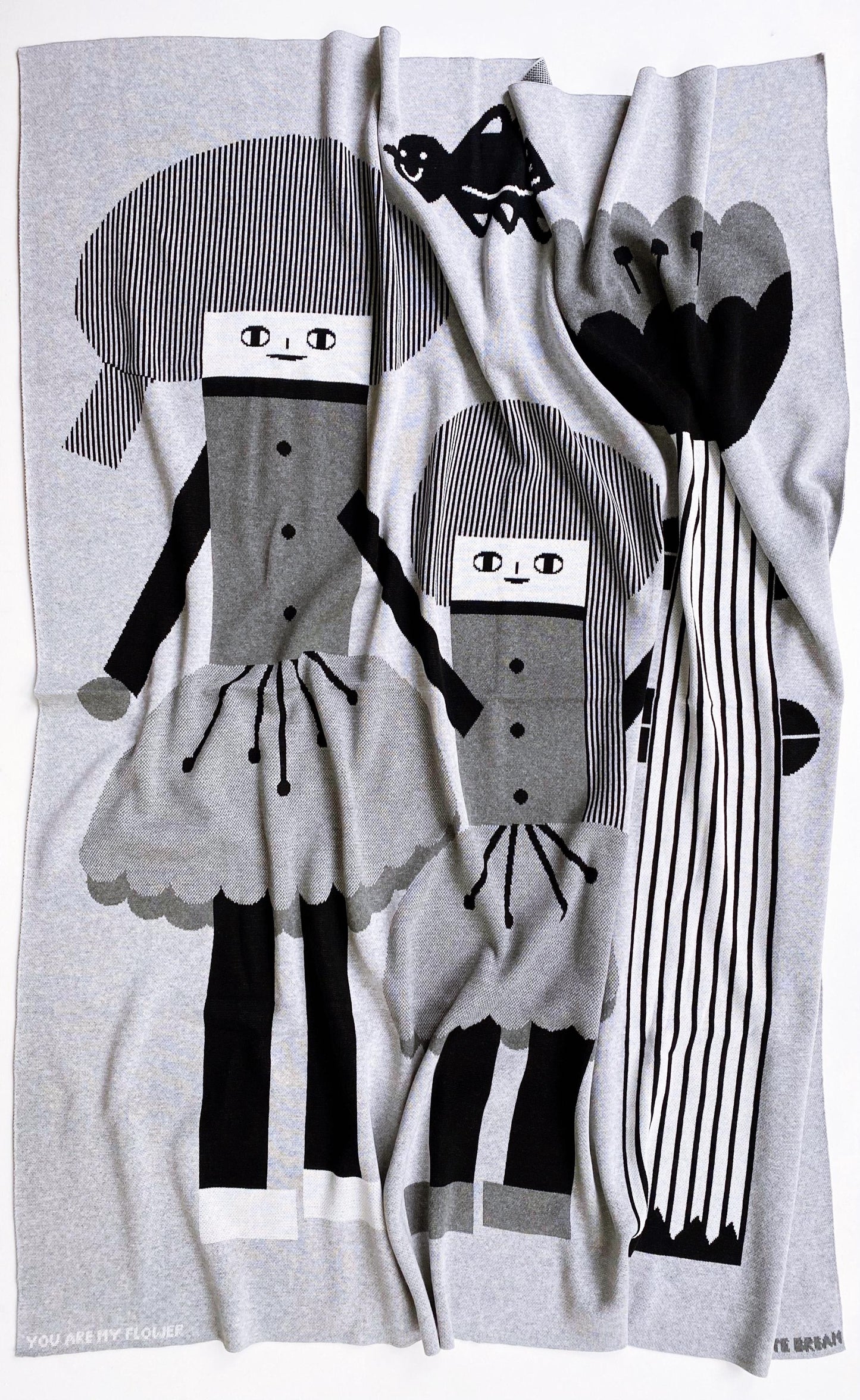 Knitted blanket with cartoon character design on a white background