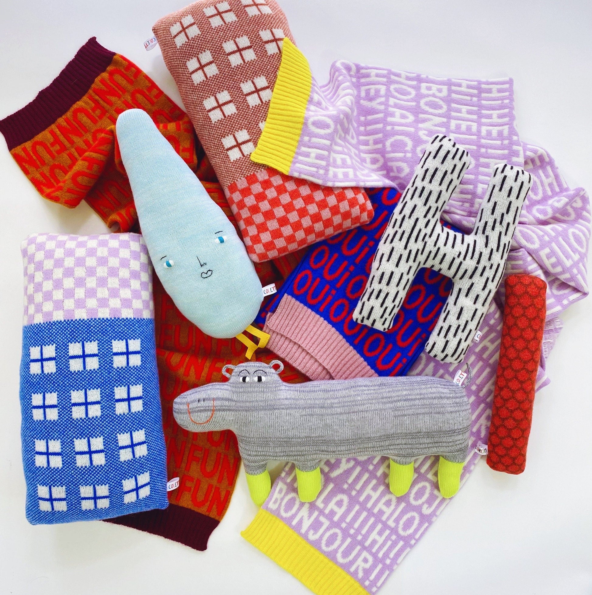 Collection of colorful knitted blankets with various patterns and text on a white background