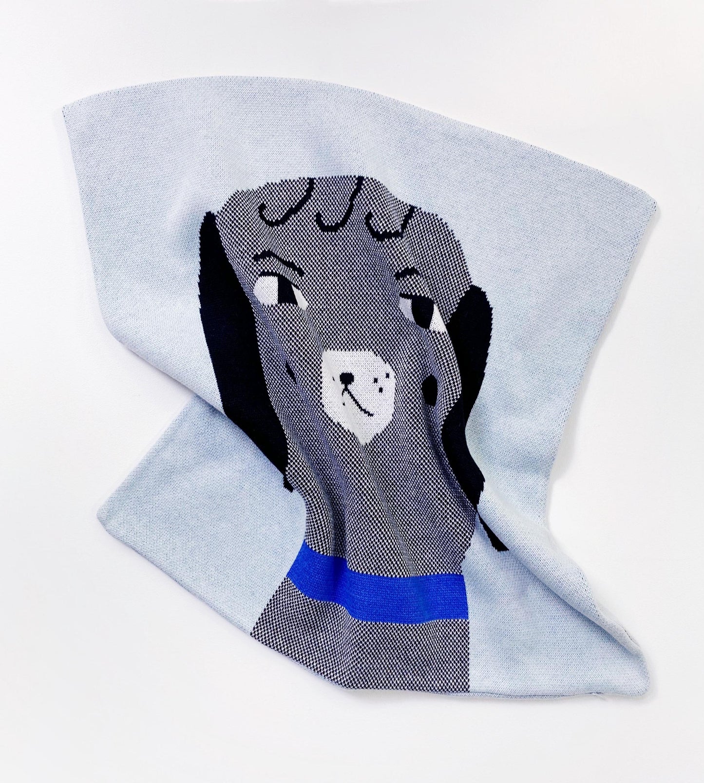 Gray dog themed pillow with a blue collar on a light gray background
