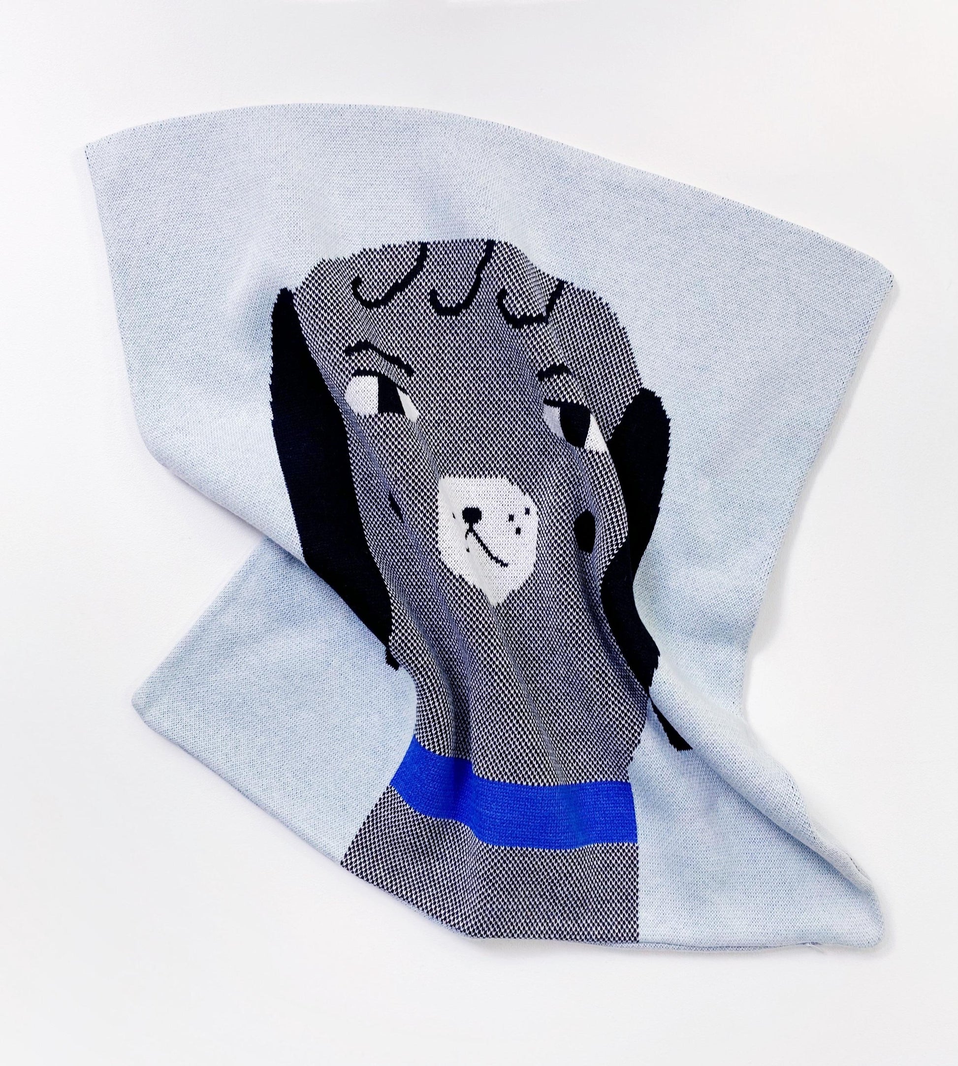 Gray dog themed pillow with a blue collar on a light gray background