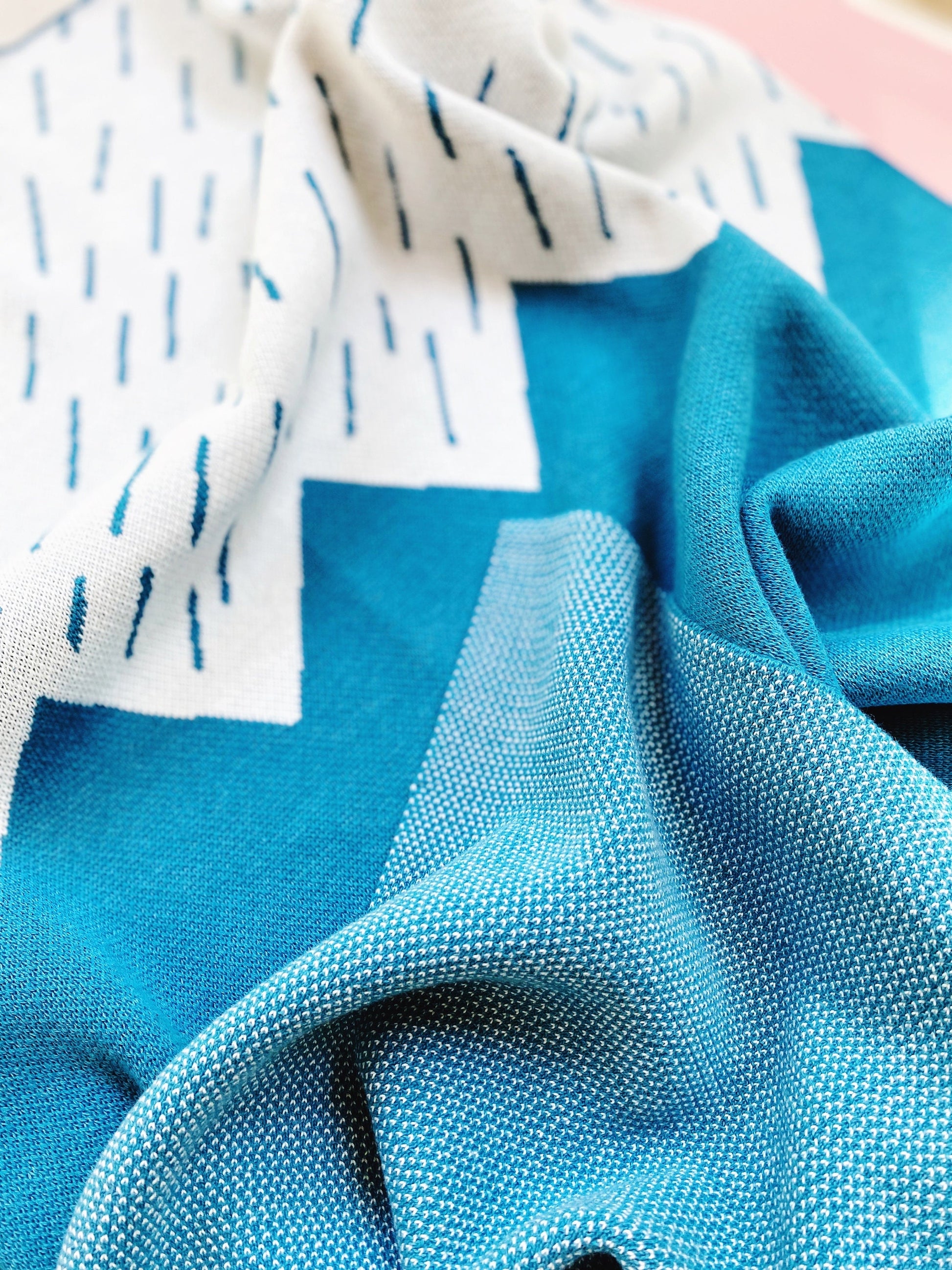 Close-up of blue knit fabric with a textured pattern