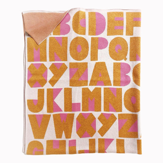 Knitted blanket with a colorful alphabet letter pattern on a white background