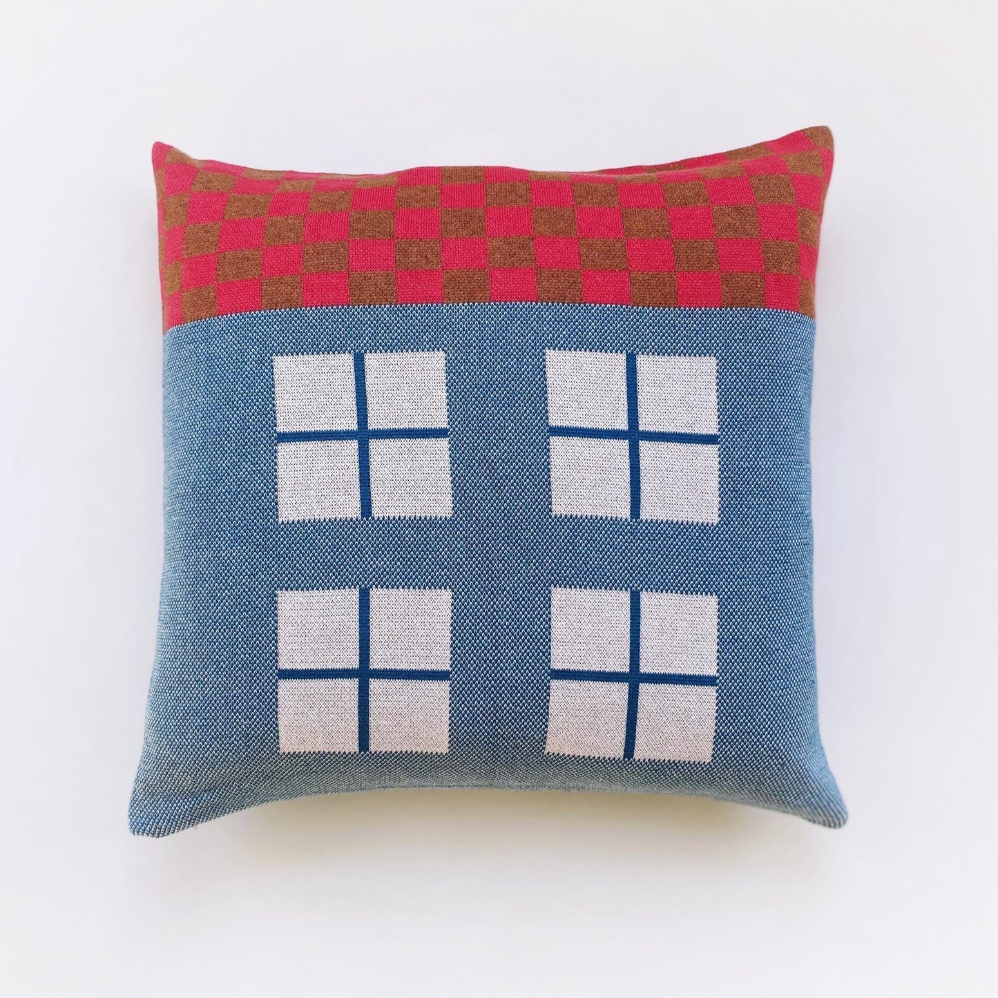 Decorative pillow with a house design on a white background