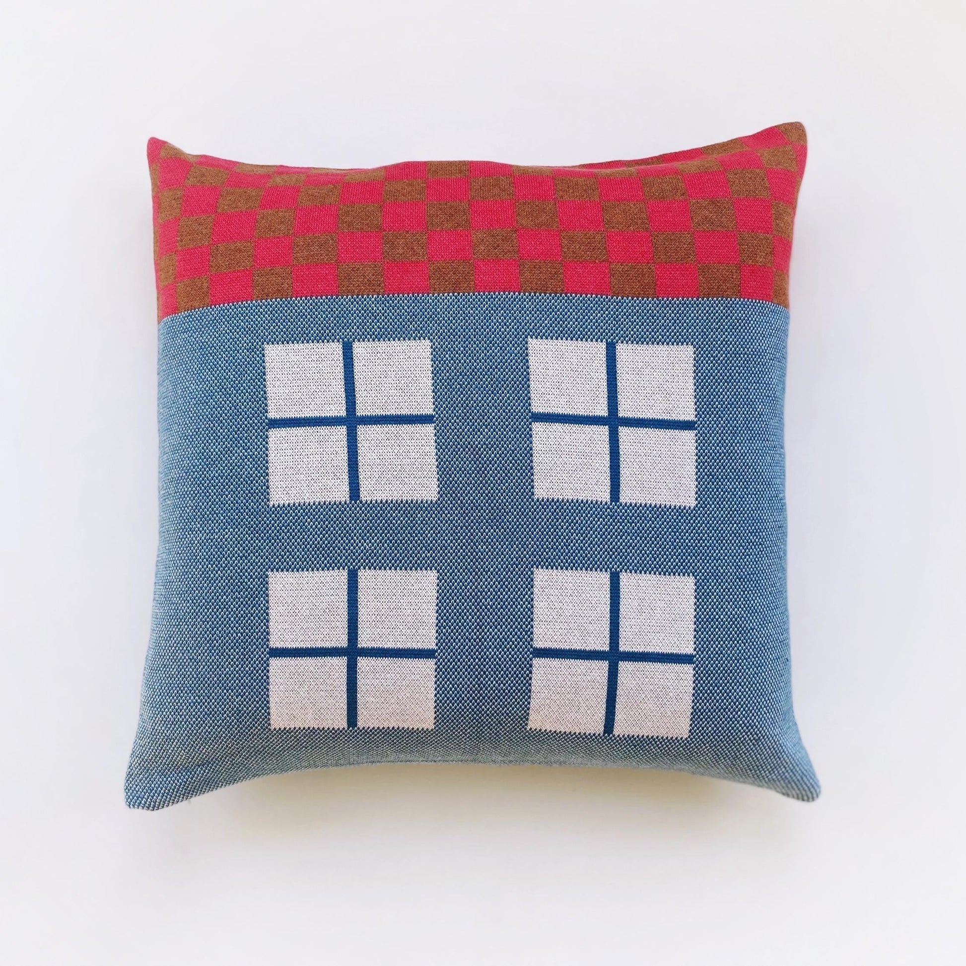 Decorative pillow with a house design on a white background