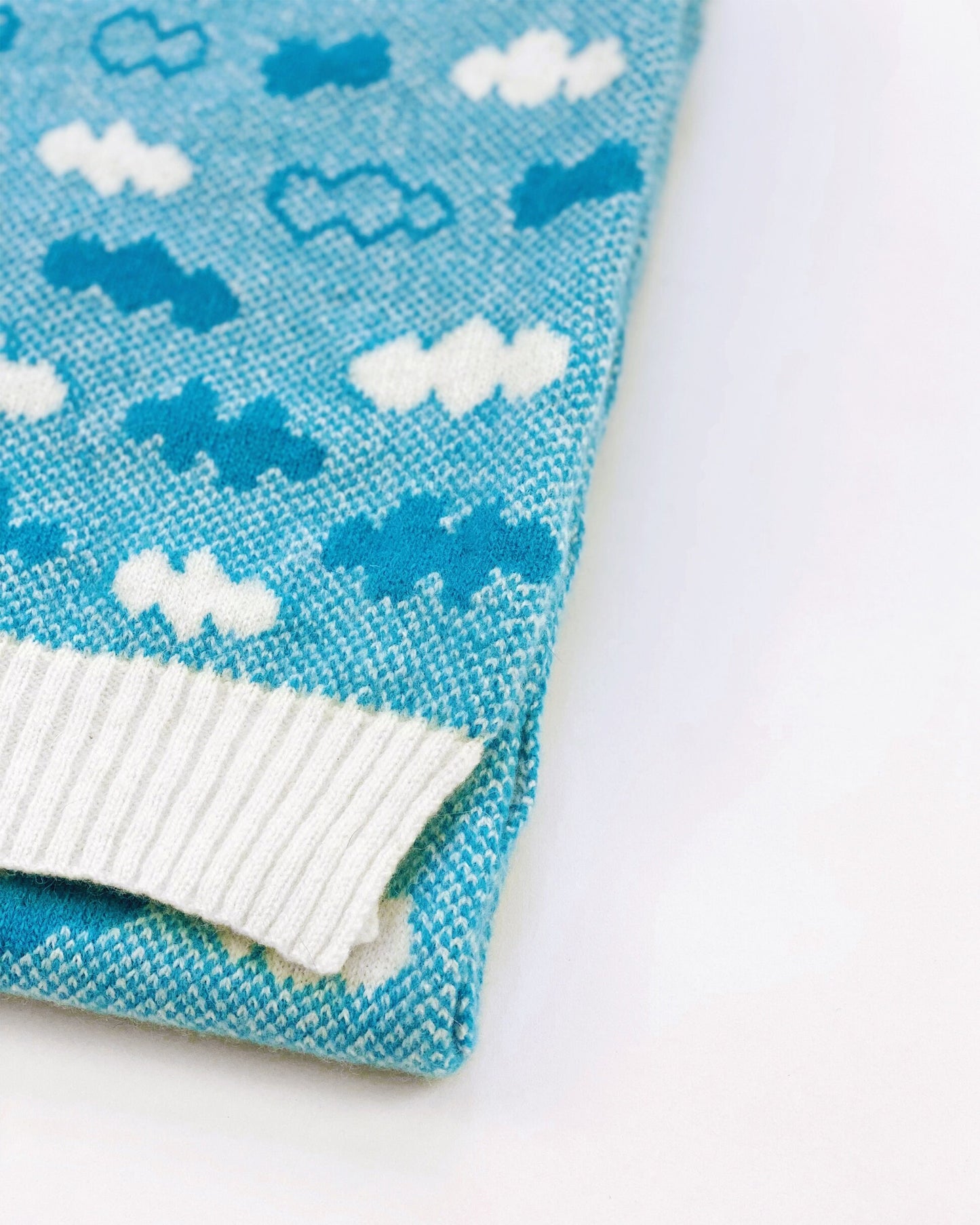 Knitted scarf with cloud pattern on a white background