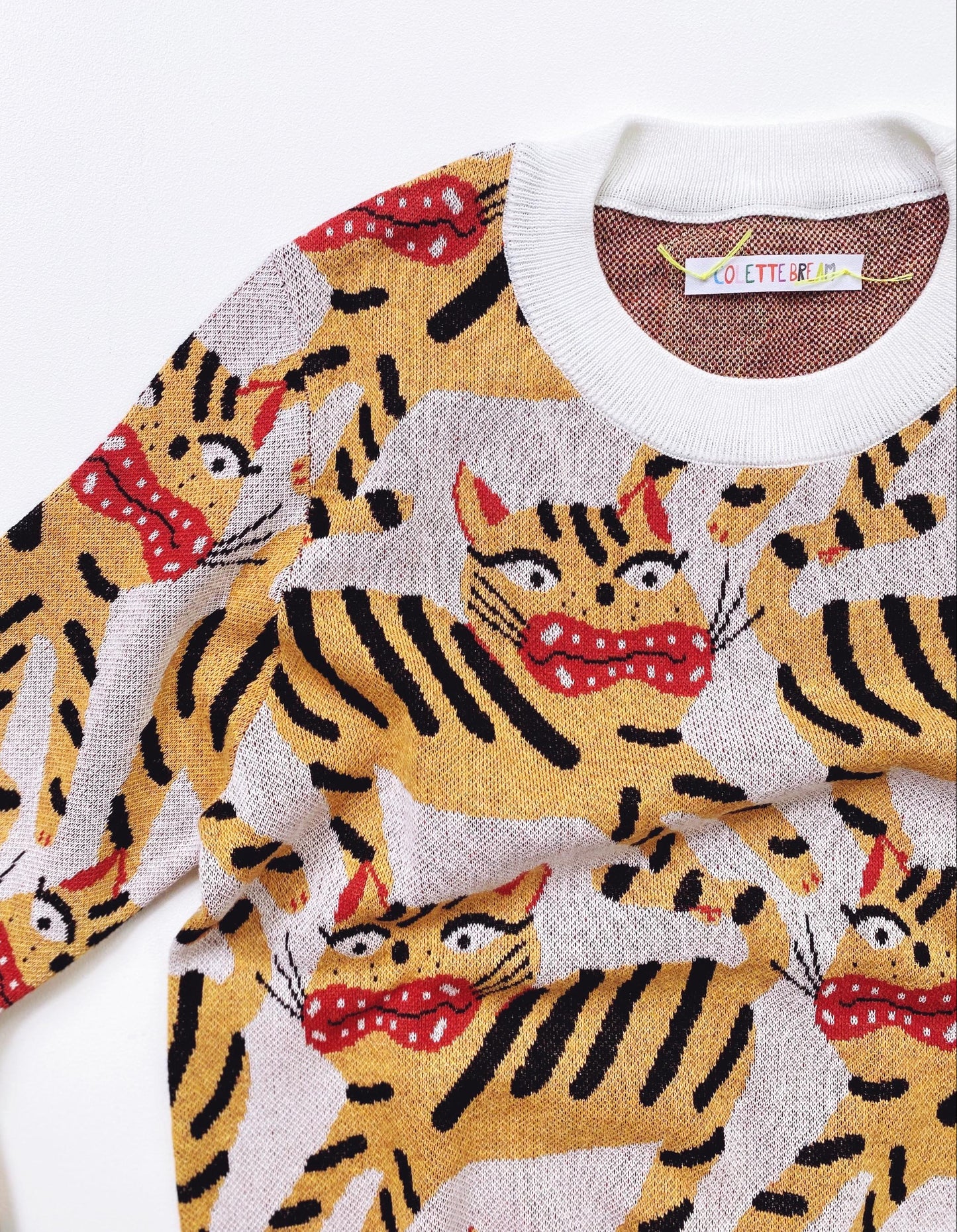 Knitted sweater with Hariko Tora tiger pattern on a white background